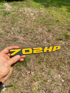 702HP badge