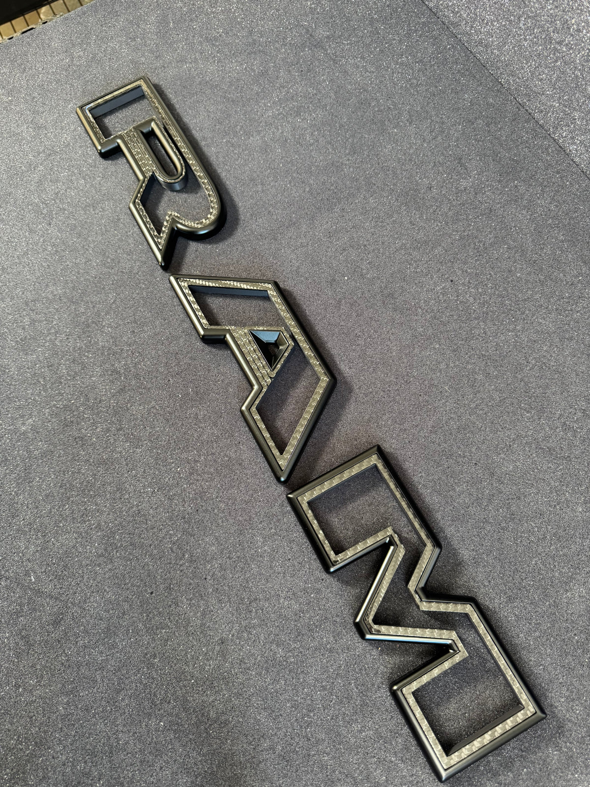 Color matched 3D RAM grille letters