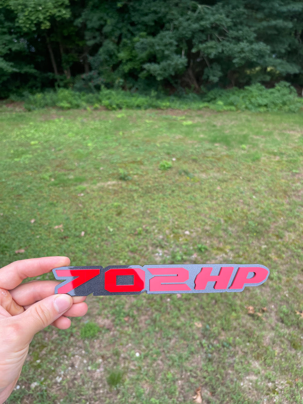 702HP grille badge