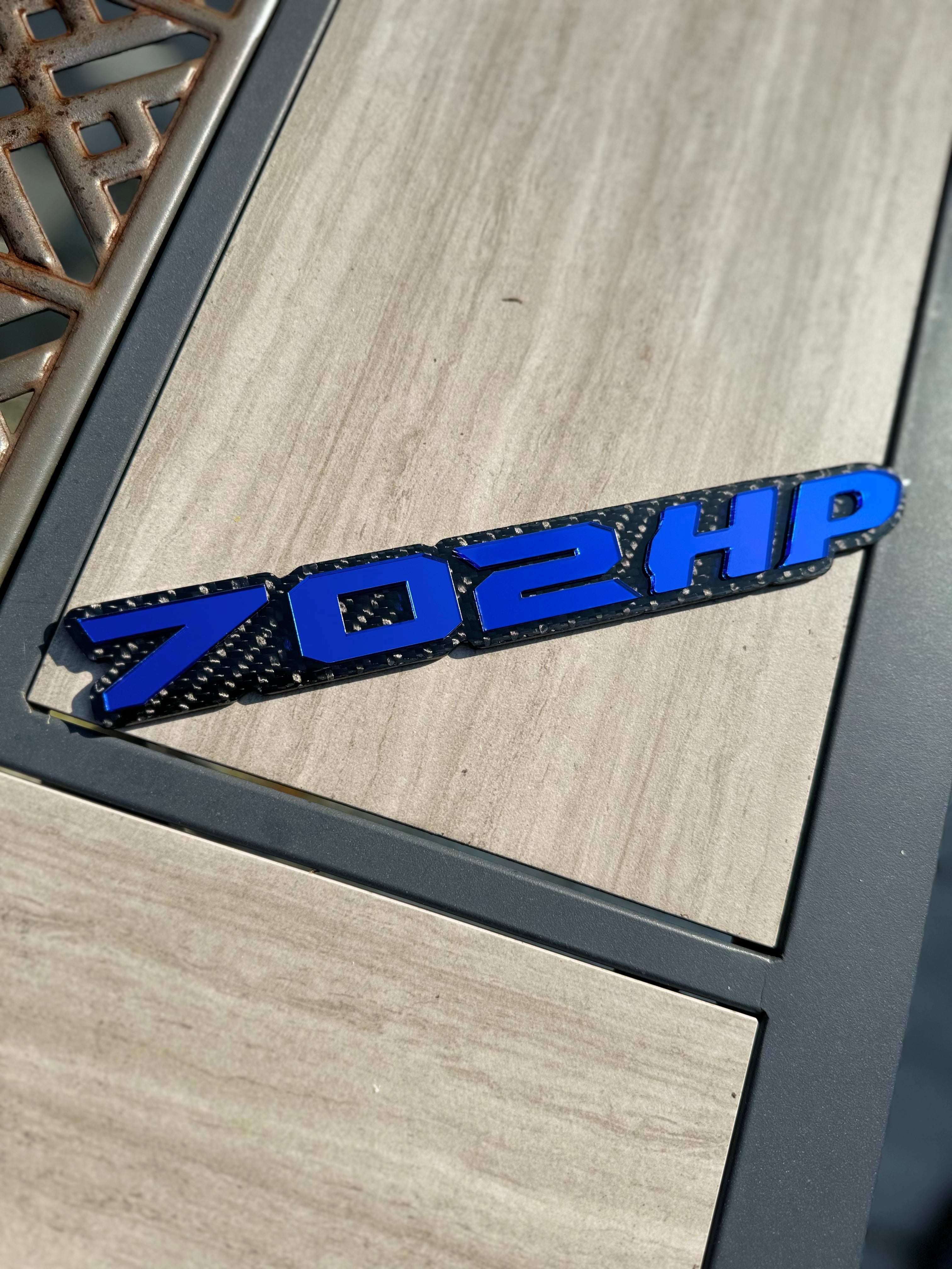 702HP badge