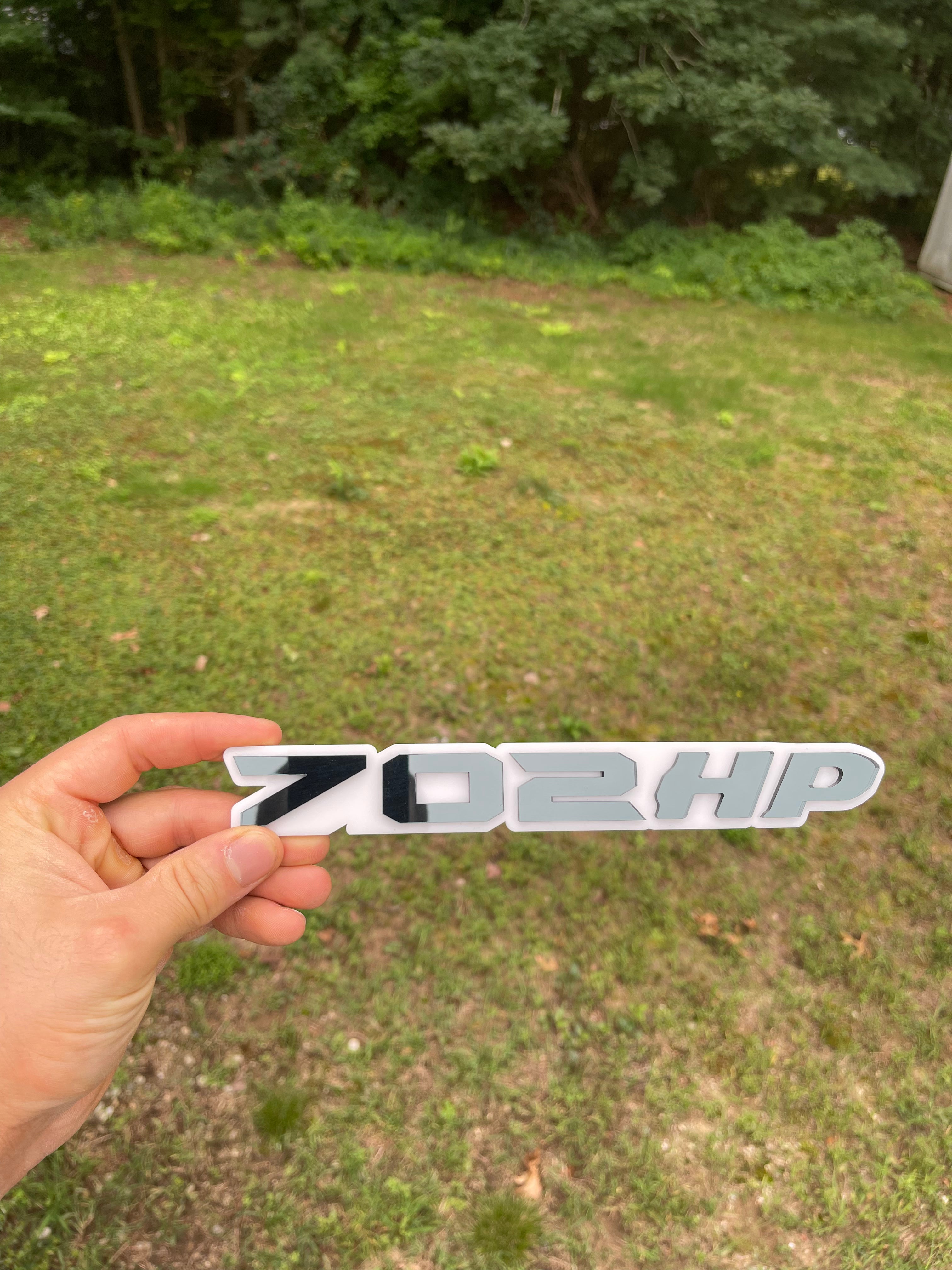 702HP grille badge
